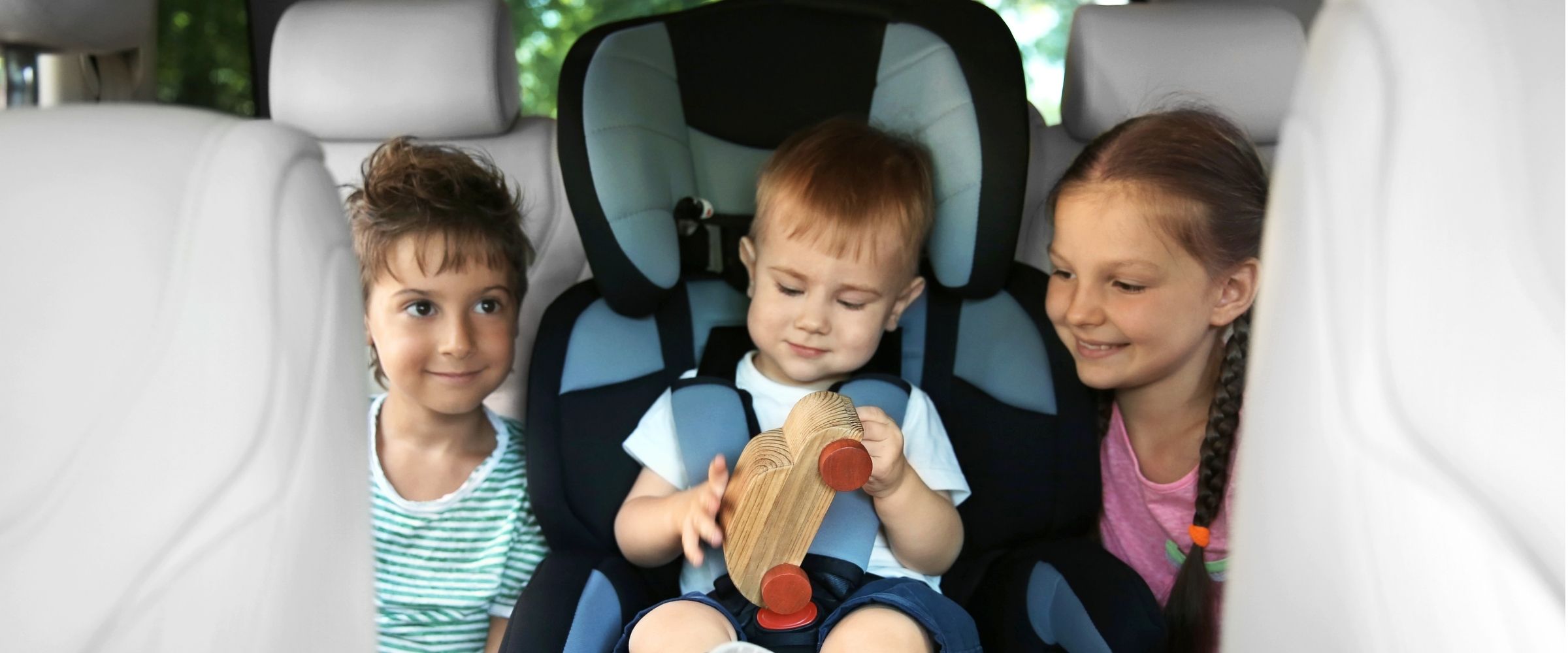 Family rental car pickup at Athens Airport with luggage and child seats